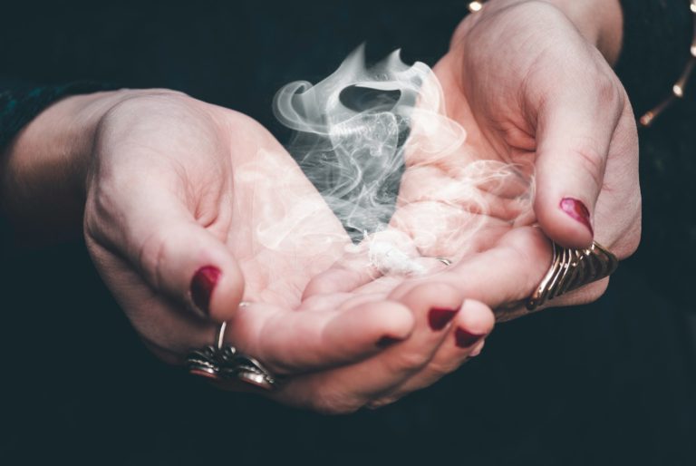 witch hands with smoke