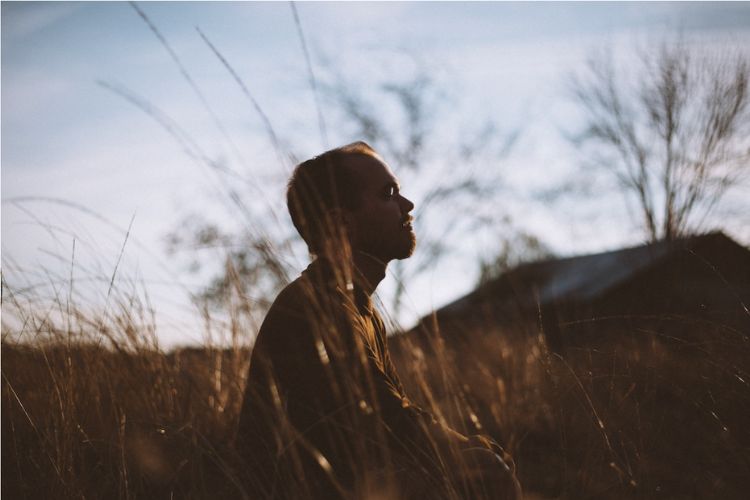 man sitting in a field