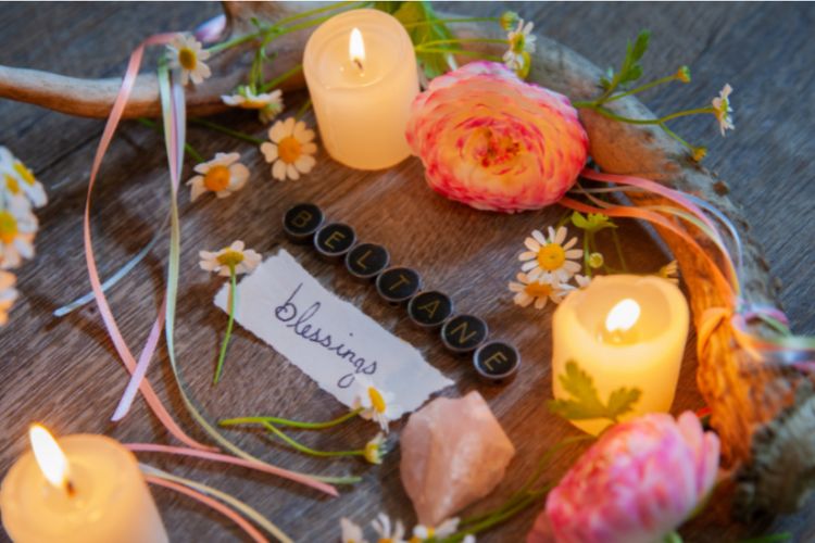 blessed beltane altar with candles and ribbons