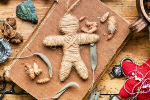 string poppet on tabletop with ribbons