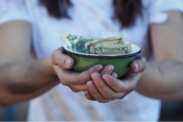 woman holding a green bowl filled with cash