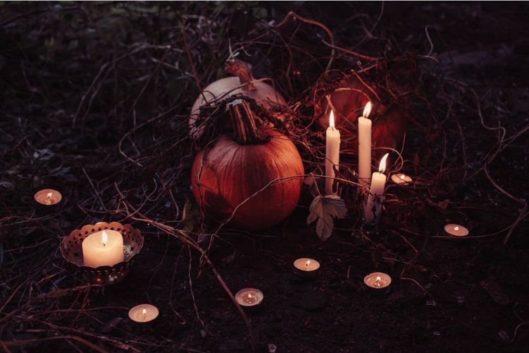 pumpkin altar at night with tea light candles